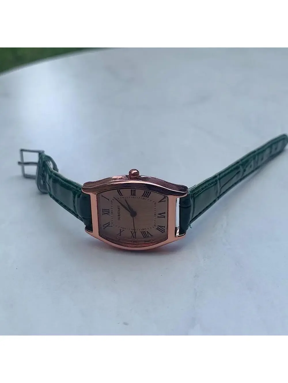 Minimalistic essential vintage style gold and green leather style band watch. 9